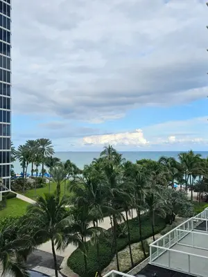 a view of the beach from the balcony of a resort at Sunny Isles Oceanfront Apartment for Two in Sunny Isles Beach