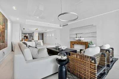 a living room with a white couch and a table at Auberge Blue by Rove Travel Oceanfront with Balcony in Fort Lauderdale