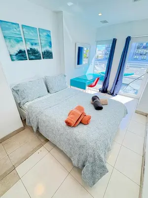 a bedroom with a bed with two towels on it at Incredible South Beach Penthouses with private terrace in Miami Beach