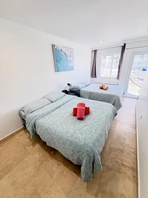 a bedroom with two beds with red objects on them at Incredible South Beach Penthouses with private terrace in Miami Beach