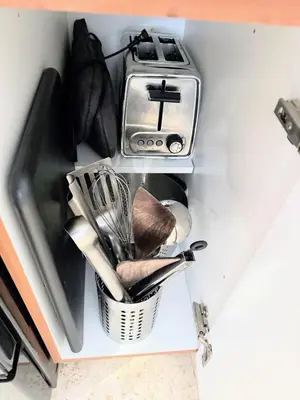 a basket of utensils next to a kitchen sink at SOFI NEW! King Bed, Beach, BBQ, Gated! in Miami Beach