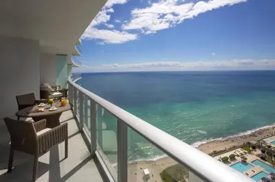 a balcony with a view of the ocean at 39th Floor Oceanfront Penthouse with Pool & Gym in Hollywood
