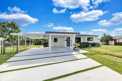 a white house with a pavilion in a yard at Trendy Waterfront Pool Home Beach Casino Airport in Hollywood