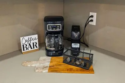 a coffeemaker on a counter with a coffee bar sign at Luxury 4BR Retreat | Pool • Kitchen in Goulds