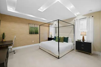a bedroom with a canopy bed and a desk at Luxury 4BR Retreat | Pool • Kitchen in Goulds