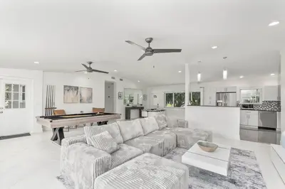 a living room with a couch and a pool table at Casa Moderna 3 Bed 2 Bath with Private Patio and BBQ in North Miami Beach
