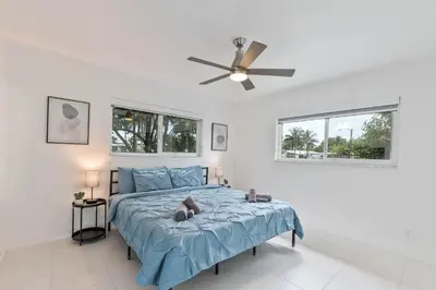 a bedroom with a bed and a ceiling fan at Casa Moderna 3 Bed 2 Bath with Private Patio and BBQ in North Miami Beach