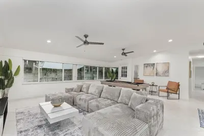 a living room with a couch and a pool table at Casa Moderna 3 Bed 2 Bath with Private Patio and BBQ in North Miami Beach