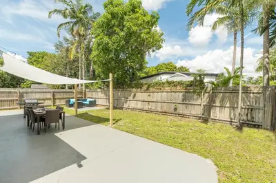a patio with a table and chairs and a fence at Casa Moderna 3 Bed 2 Bath with Private Patio and BBQ in North Miami Beach