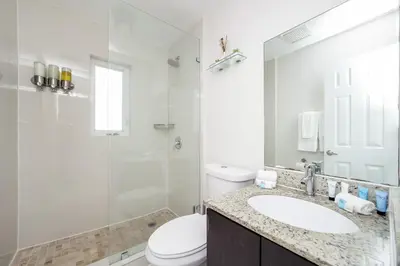 a bathroom with a toilet and a sink and a shower at The Donovan in Miami Beach