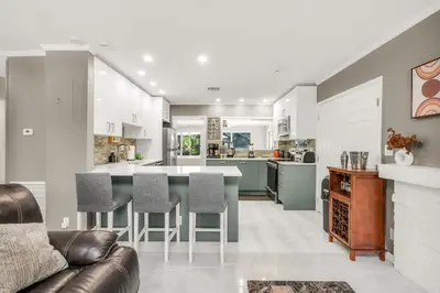 a kitchen and living room with a table and chairs at Backyard Oasis 3 Hole Golf Pool Fire Pit in Fort Lauderdale