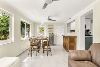 a kitchen and dining room with a table and chairs at Backyard Oasis 3 Hole Golf Pool Fire Pit in Fort Lauderdale