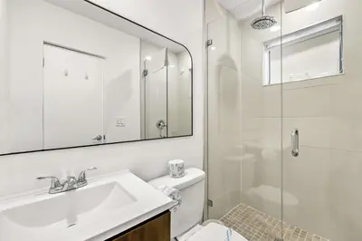 a white bathroom with a sink and a shower at Chic Modern Studio with Queen Bed in Fort Lauderdale