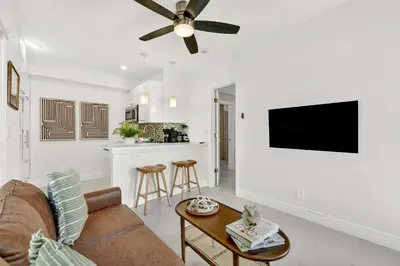 a living room with a couch and a ceiling fan at Chic Modern Studio with Queen Bed in Fort Lauderdale