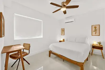 a bedroom with a bed and a ceiling fan at Chic Modern Studio with Queen Bed in Fort Lauderdale