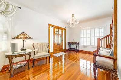 a living room with a table and a chair at Walk to Las Olas! Old Florida Oasis with Hot Tub in Fort Lauderdale