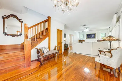 a living room with a staircase and a dining room at Walk to Las Olas! Old Florida Oasis with Hot Tub in Fort Lauderdale