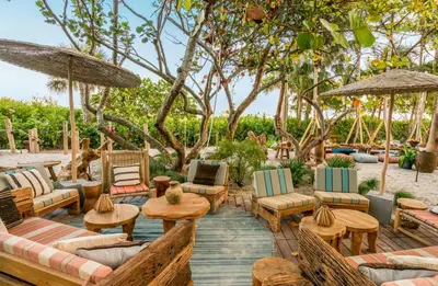 a patio with chairs and tables and umbrellas at Amazing View 1 Hotel Corner Unit 1BR/1BA w Balcony in Miami Beach