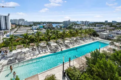 an overhead view of a swimming pool with chaise lounges and chairs at Condo at 72 Park - Miami Beach Area & Resort Facilities in Miami Beach