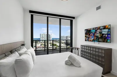 a living room with a couch and a large window at Condo at 72 Park - Miami Beach Area & Resort Facilities in Miami Beach