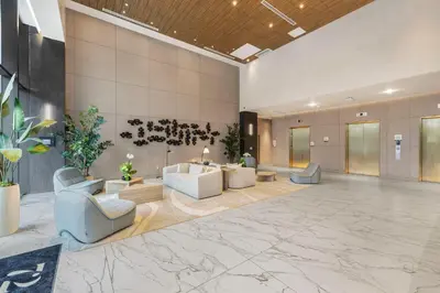 a lobby with couches and chairs in a building at Resort & Beach - The Ideal Condo at 72 Park in Miami Beach