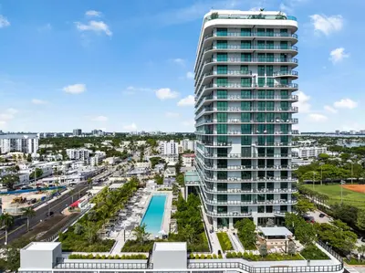 an aerial view of a tall building with a pool at Resort & Beach - The Ideal Condo at 72 Park in Miami Beach