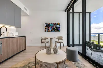 a kitchen and living room with a table and chairs at Resort & Beach - The Ideal Condo at 72 Park in Miami Beach