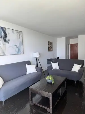 a living room with two blue couches and a table at Beachfront 2BR at The Tides | EPIC Stay in Hollywood