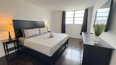 a bedroom with a large bed and two windows at Beachfront 2BR at The Tides | EPIC Stay in Hollywood
