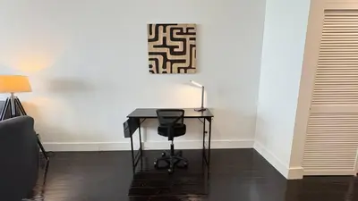 a desk with a lamp on it next to a wall at Beachfront 2BR at The Tides | EPIC Stay in Hollywood