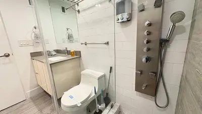 a bathroom with a toilet and a shower at Beachfront 2BR at The Tides | EPIC Stay in Hollywood