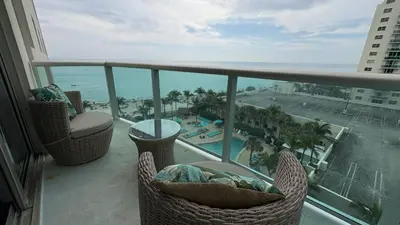 a balcony with chairs and a view of the ocean at Beachfront 2BR at The Tides | EPIC Stay in Hollywood