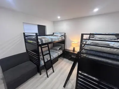 a room with two bunk beds and a couch at Place to stay in Hallandale Beach