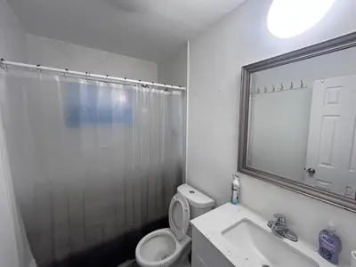 a bathroom with a toilet and a shower and a sink at Place to stay in Hallandale Beach