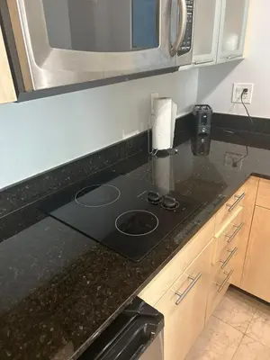 a kitchen counter with a stove and a microwave at Ocean Breeze Condo - Intracostal and Ocean views at GalleryOne in Fort Lauderdale