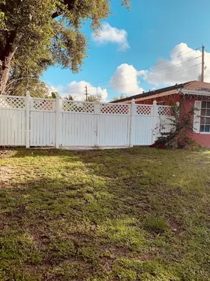 a white fence in a yard next to a house at Zen Garden Studio in Hollywood
