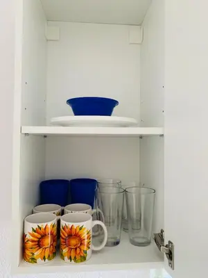 a shelf with cups and vases on it at Zen Garden Studio in Hollywood