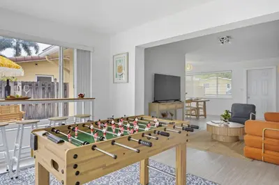 a living room with a foosball table at Positano Ville I Waterfront and Grill I 10 min Beach in Fort Lauderdale