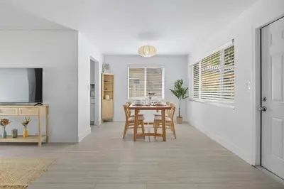 a kitchen and dining room with a table and chairs at Positano Ville I Waterfront and Grill I 10 min Beach in Fort Lauderdale
