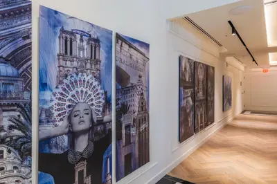 a hallway with paintings on the walls of an art gallery at The Avenue Hotel Coral Gables in Miami
