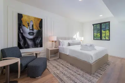 a bedroom with a bed and a large painting on the wall at The Avenue Hotel Coral Gables in Miami