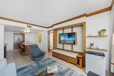 a living room with a couch and a desk at Skyline View Private Residence at Carillon Resort - 705 in Miami Beach