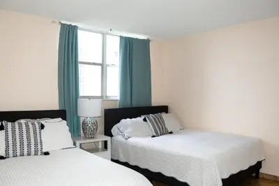 a bedroom with two beds and a window at The Azul Beachview Get away in Hollywood