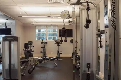 a gym with several treadmills and weights at The Azul Beachview Get away in Hollywood