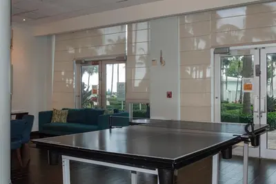 a ping pong table in a living room at The Azul Beachview Get away in Hollywood