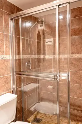 a shower with a glass door in a bathroom at The Azul Beachview Get away in Hollywood