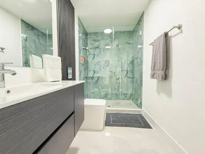 a bathroom with a shower and a toilet and a sink at Luxury Suite Studio with Kitchen & Spa Shower in Miramar
