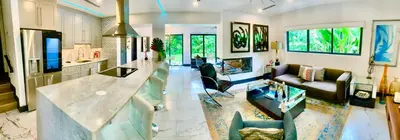 a large living room with a kitchen and a living room at MIAMi MID-CENTURY GEM in North Miami Beach