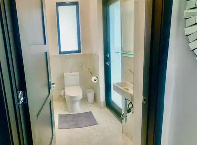 a small bathroom with a toilet and a sink at MIAMi MID-CENTURY GEM in North Miami Beach