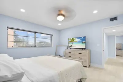 a bedroom with a bed and a television in it at Las Olas & Beachside getaway with pool in Fort Lauderdale